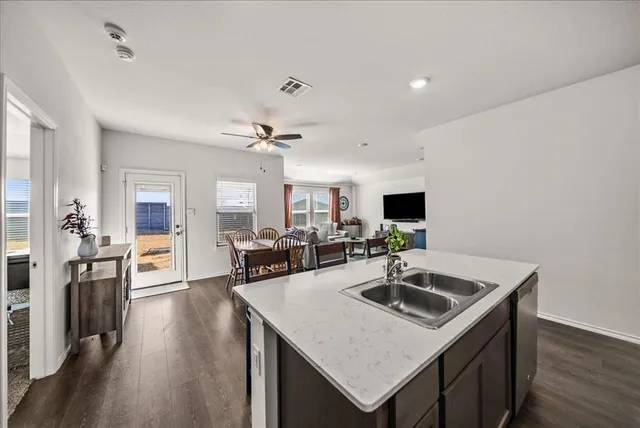 a kitchen with a sink a counter space and appliances