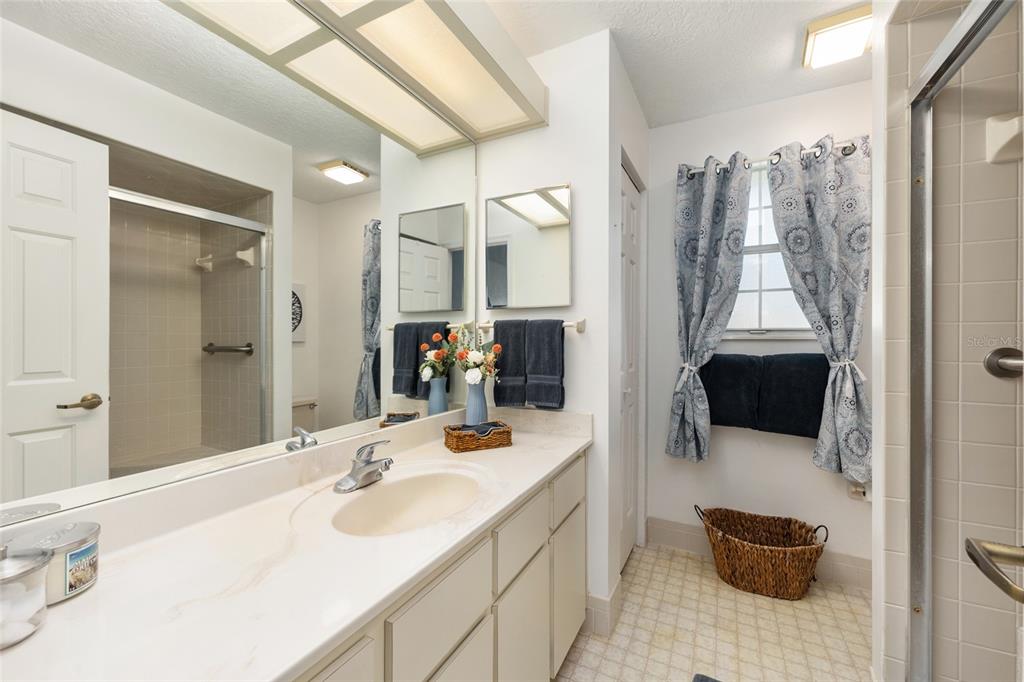 8038 Southwest 108th Loop Ocala, FL 34481 - Photo 22 of 48 a bathroom with a sink a toilet and a large mirror