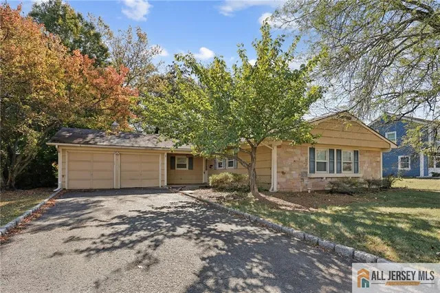 front view of a house with a tree