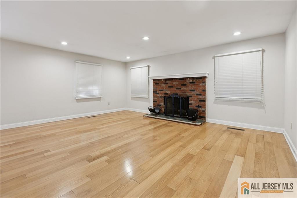1 Landry Road Somerset, NJ 08873 - Photo 3 of 17 a view of empty room with wooden floor and fireplace