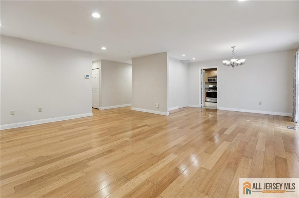 1 Landry Road Somerset, NJ 08873 - Photo 4 of 17 a view of an empty room with wooden floor