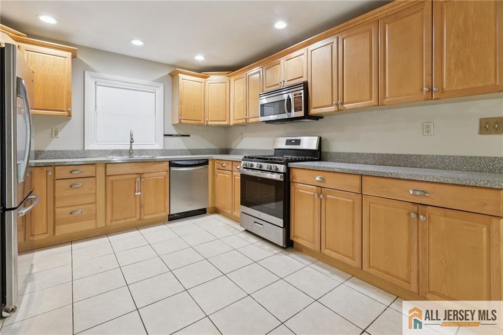 1 Landry Road Somerset, NJ 08873 - Photo 9 of 17 a kitchen with stainless steel appliances granite countertop a sink and cabinets