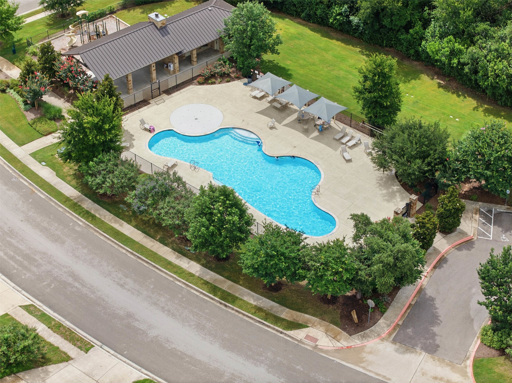 1113 Modoc Way Kyle, TX 78640 - Photo 32 of 34 An inviting community pool awaits, nestled beside a playground and recreational pavilion.