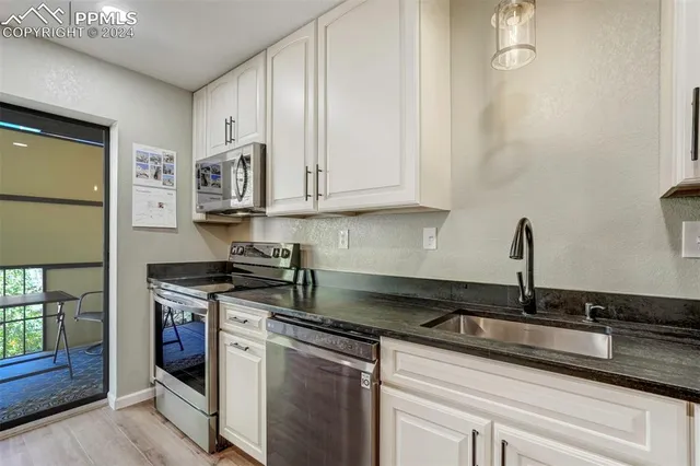 a kitchen with stainless steel appliances a stove a microwave and cabinets