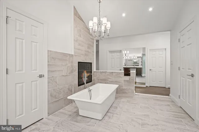 a living room with fireplace furniture and a chandelier