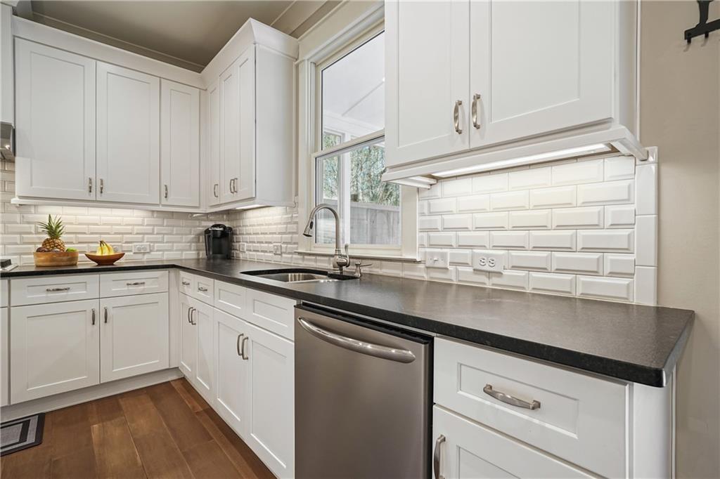 6243 Allen Ivey Road Mableton, GA 30126 - Photo 12 of 46 a kitchen with granite countertop white cabinets and white appliances
