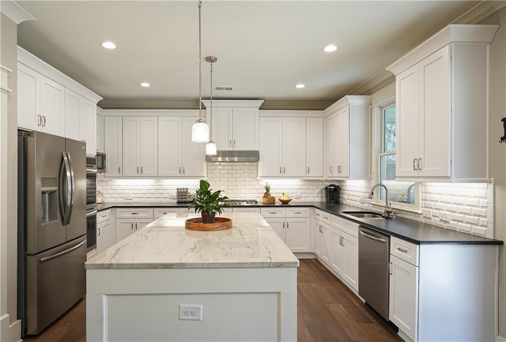 6243 Allen Ivey Road Mableton, GA 30126 - Photo 13 of 46 a kitchen with a sink stainless steel appliances and white cabinets