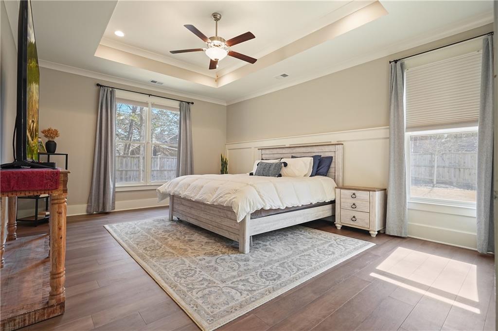 6243 Allen Ivey Road Mableton, GA 30126 - Photo 20 of 46 a bedroom with a bed and a chandelier