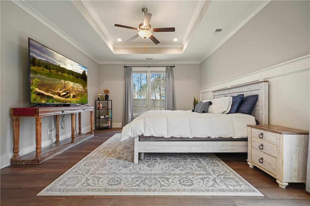 6243 Allen Ivey Road Mableton, GA 30126 - Photo 21 of 46 a bed sitting in a bedroom next to a window with a rug