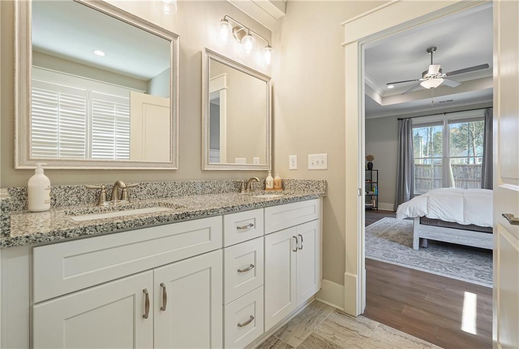 6243 Allen Ivey Road Mableton, GA 30126 - Photo 23 of 46 a en suite bathroom with double sink and a mirror