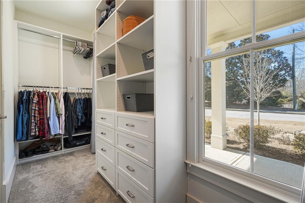 6243 Allen Ivey Road Mableton, GA 30126 - Photo 27 of 46 a view of walk in closet with clothes and shoes
