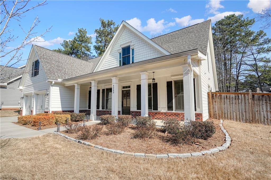 6243 Allen Ivey Road Mableton, GA 30126 - Photo 3 of 46 a view of a white house with a small yard and wooden fence