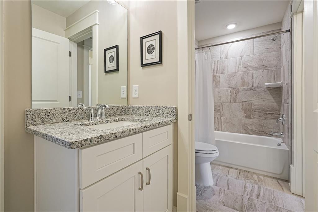 6243 Allen Ivey Road Mableton, GA 30126 - Photo 31 of 46 a bathroom with a granite countertop sink toilet and shower