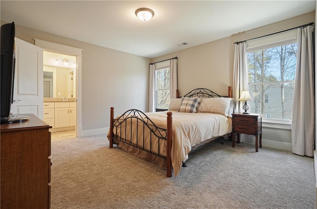 6243 Allen Ivey Road Mableton, GA 30126 - Photo 32 of 46 a bedroom with a bed and a flat tv screen on dresser