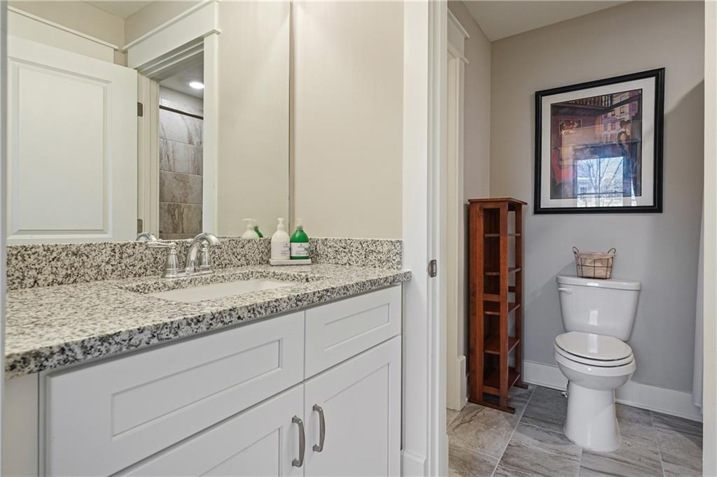 6243 Allen Ivey Road Mableton, GA 30126 - Photo 35 of 46 a bathroom with a granite countertop sink toilet and mirror