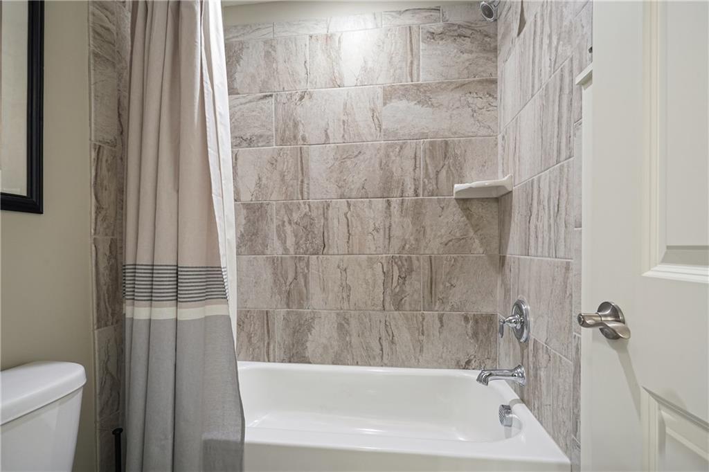 6243 Allen Ivey Road Mableton, GA 30126 - Photo 36 of 46 a bathroom with a bathtub and a toilet