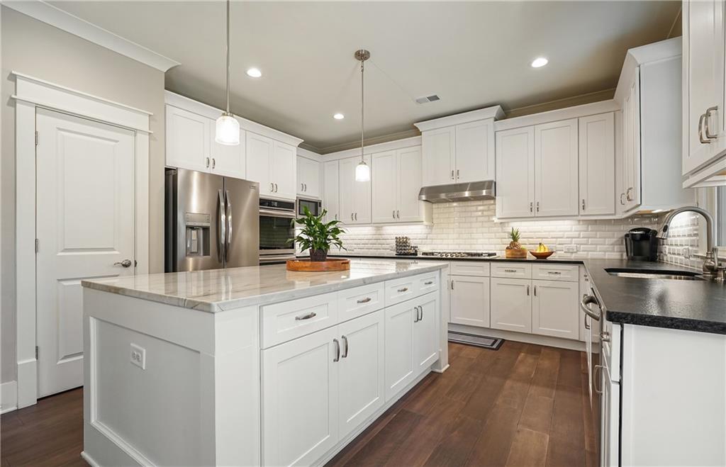 6243 Allen Ivey Road Mableton, GA 30126 - Photo 7 of 46 a kitchen with a refrigerator a sink and cabinets