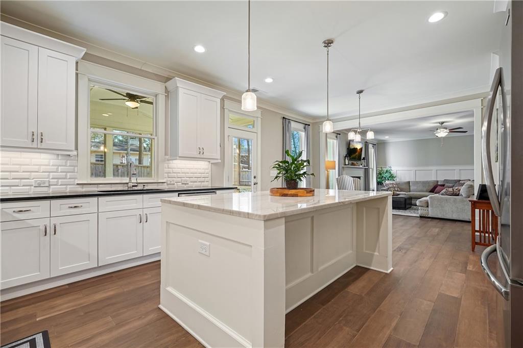 6243 Allen Ivey Road Mableton, GA 30126 - Photo 9 of 46 a large kitchen with a lot of counter space and a wooden floor