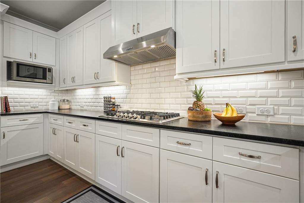 6243 Allen Ivey Road Mableton, GA 30126 - Photo 10 of 46 a kitchen with white cabinets stainless steel appliances and sink