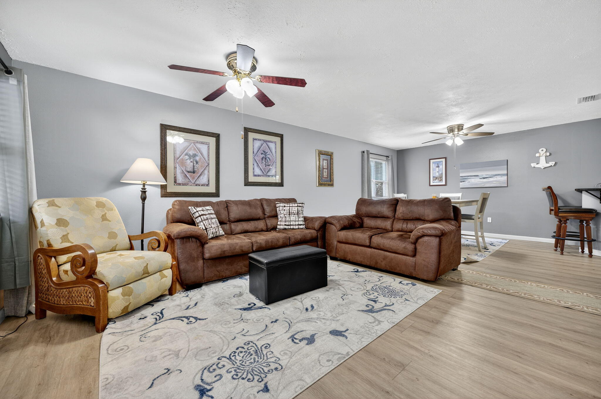 a living room with furniture and a wooden floor
