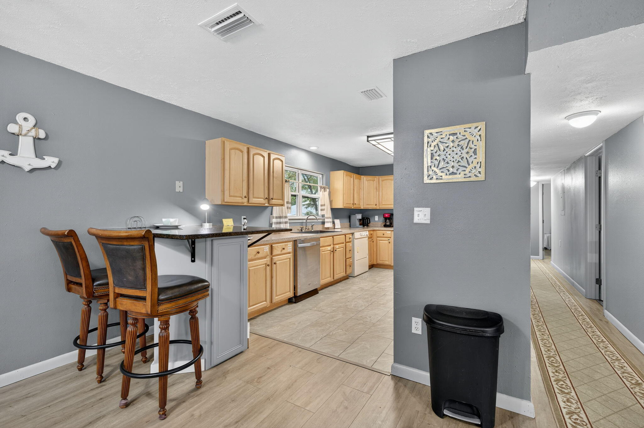 14 6th Street Shalimar, FL 32579 - Photo 15 of 64 a kitchen with granite countertop cabinets a table and chairs in it