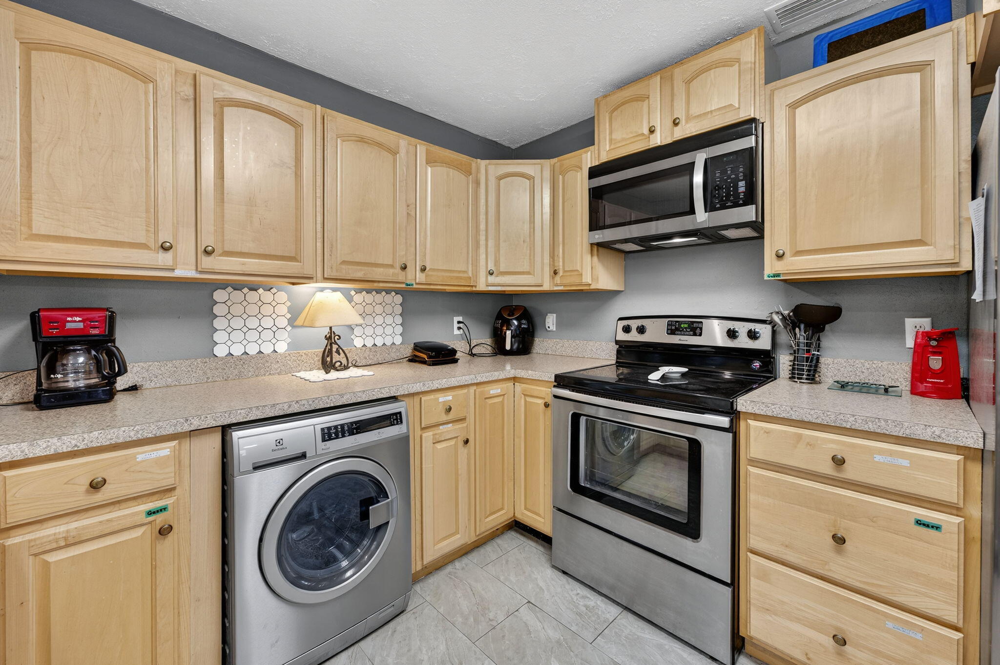 14 6th Street Shalimar, FL 32579 - Photo 20 of 64 a kitchen with stainless steel appliances granite countertop a stove a sink dishwasher and cabinets with wooden floor