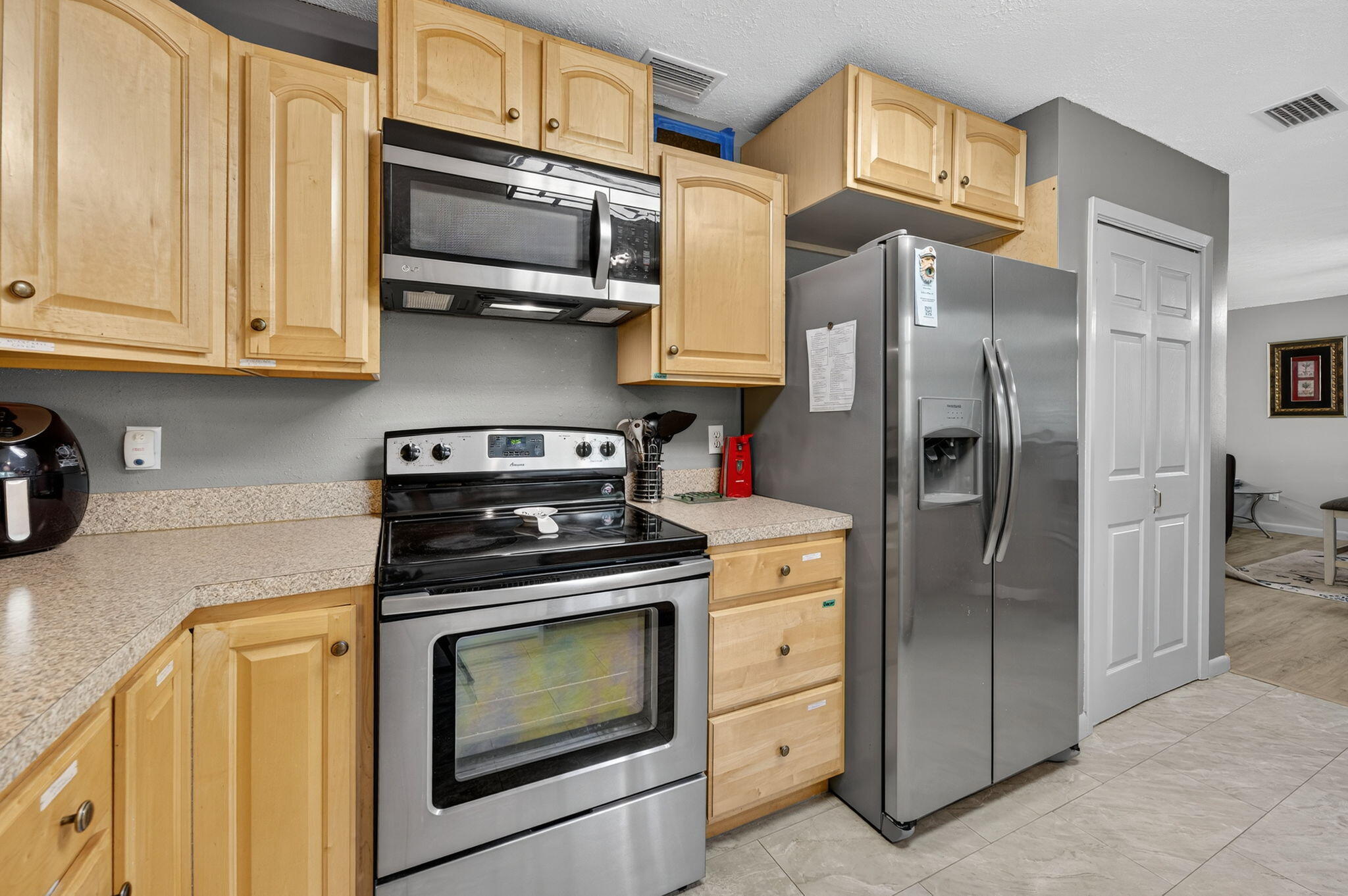 14 6th Street Shalimar, FL 32579 - Photo 21 of 64 a kitchen with stainless steel appliances granite countertop a stove a refrigerator and a cabinets with wooden floor