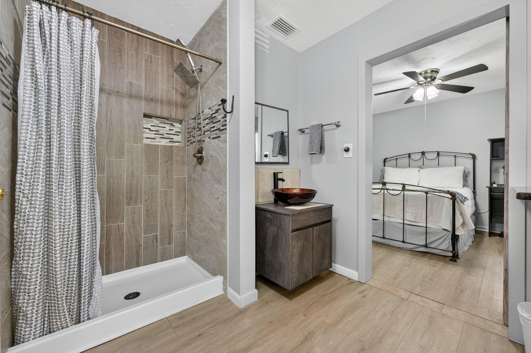 14 6th Street Shalimar, FL 32579 - Photo 29 of 64 a bathroom with a shower a sink and a mirror