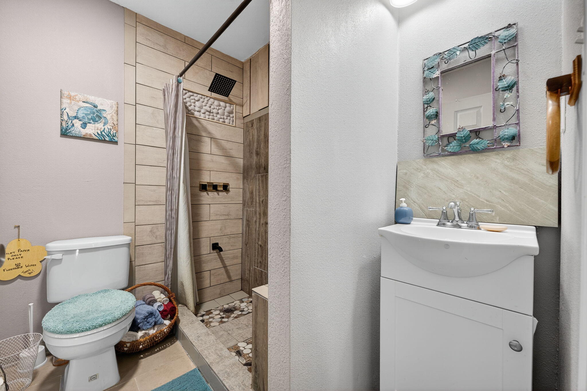 14 6th Street Shalimar, FL 32579 - Photo 49 of 64 a bathroom with a sink toilet and shower