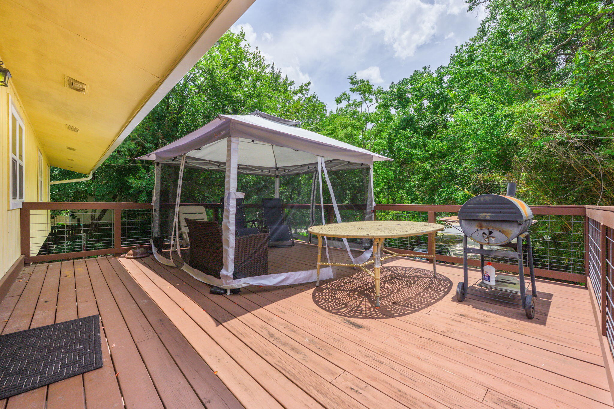 14 6th Street Shalimar, FL 32579 - Photo 57 of 64 a view of a roof deck with table and chairs under an umbrella with wooden floor