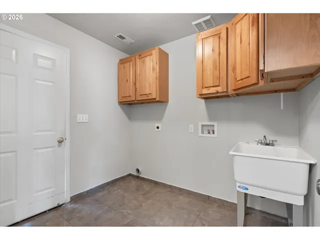 a kitchen with stainless steel appliances granite countertop a sink dishwasher and cabinets with wooden floor