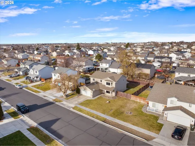 an aerial view of residential houses with outdoor space