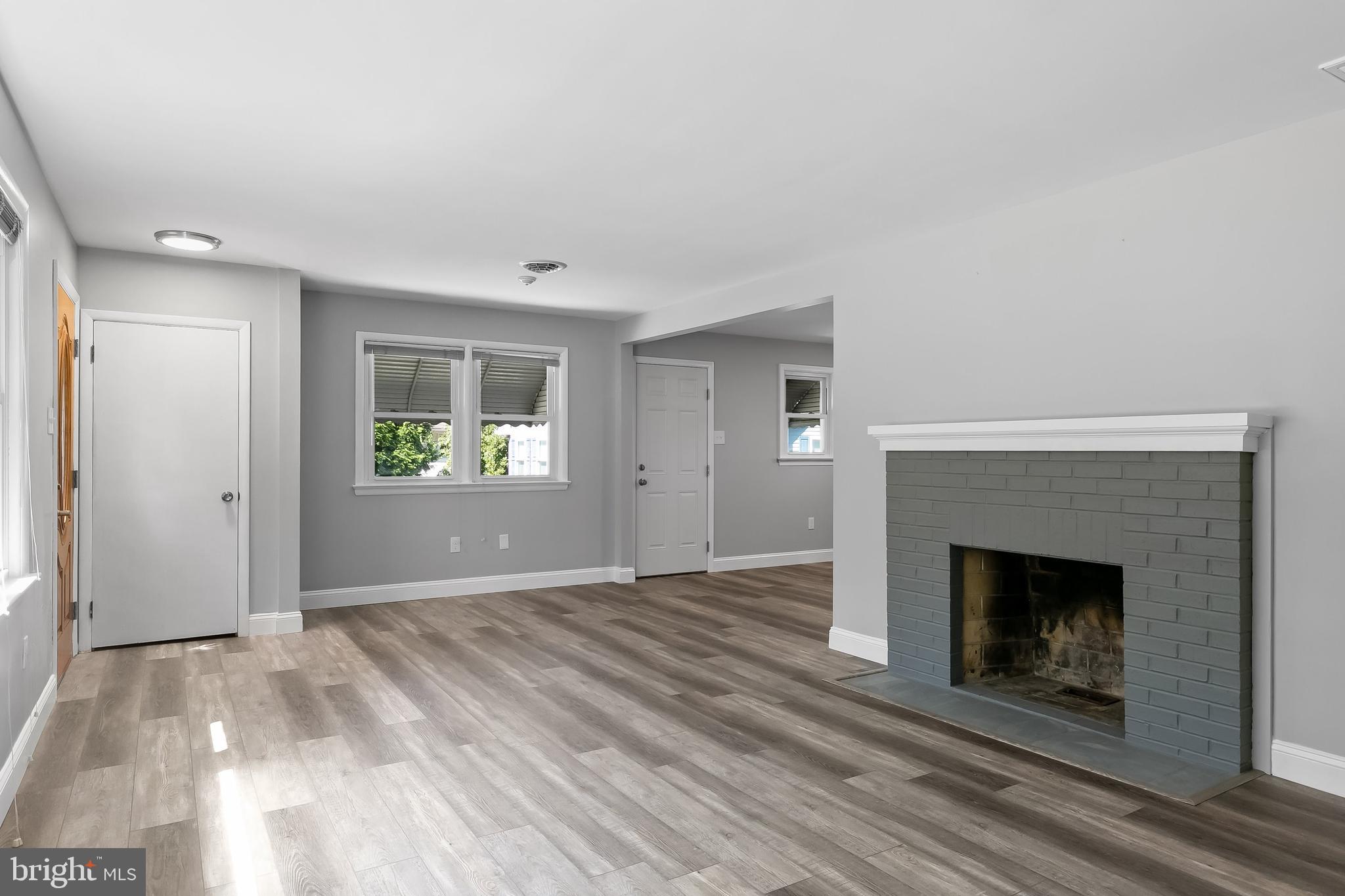 405 Hamilton Road Glassboro, NJ 08028 - Photo 7 of 28 a view of an empty room with window and a fireplace