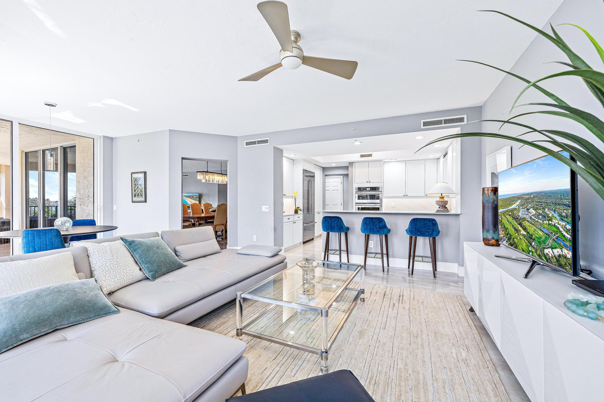 500 Highway 1, Unit 201 Jupiter, FL 33477 - Photo 12 of 38 a living room with furniture and a chandelier