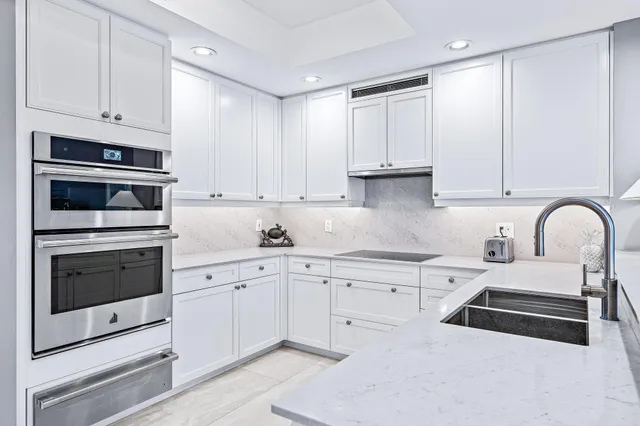 a kitchen with white cabinets and white appliances
