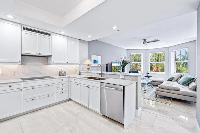a kitchen with sink refrigerator and cabinets