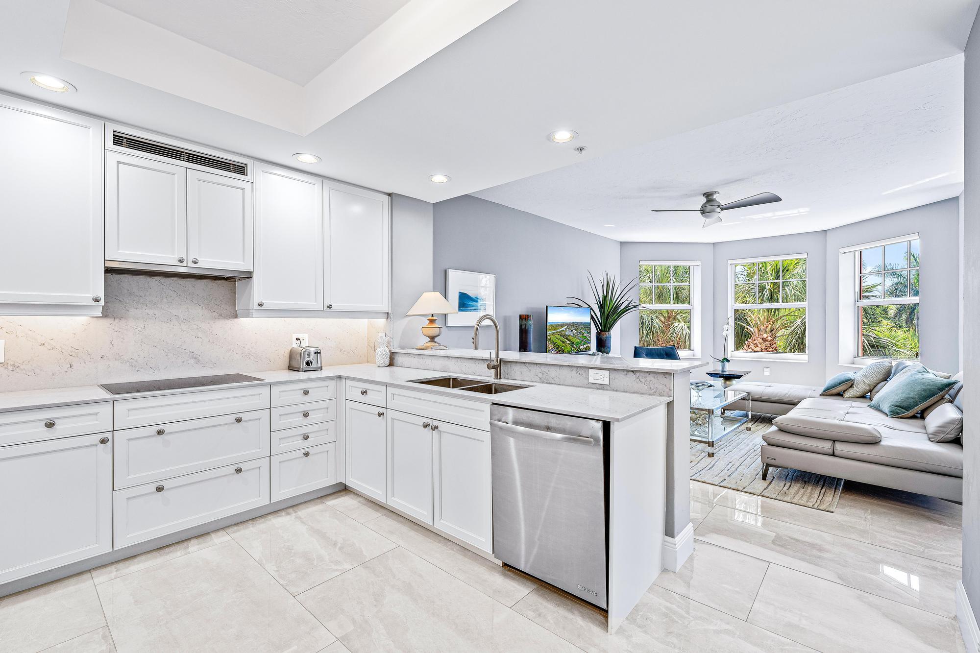 500 Highway 1, Unit 201 Jupiter, FL 33477 - Photo 15 of 38 a kitchen with sink refrigerator and cabinets