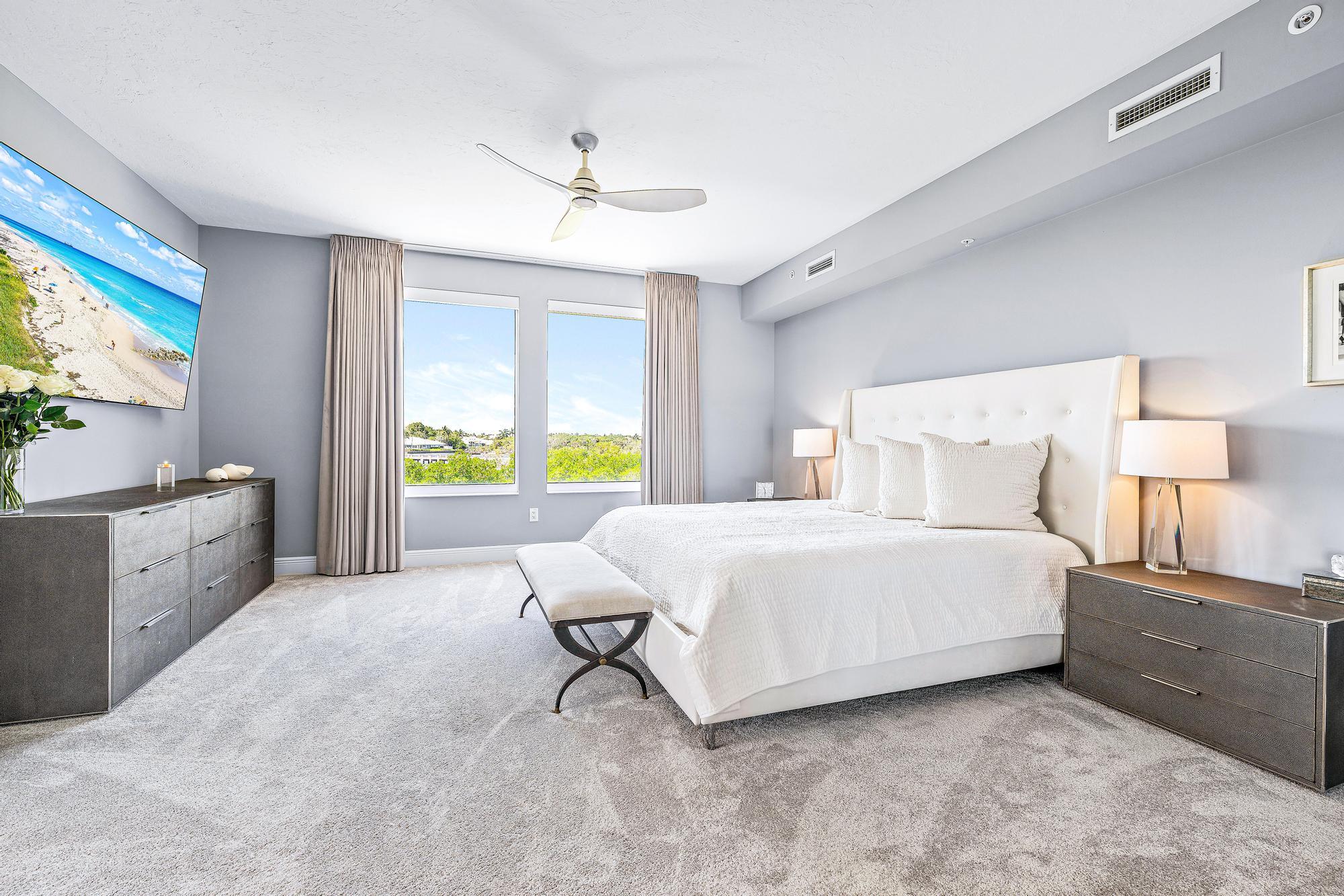 500 Highway 1, Unit 201 Jupiter, FL 33477 - Photo 17 of 38 a spacious bedroom with a bed and a dresser