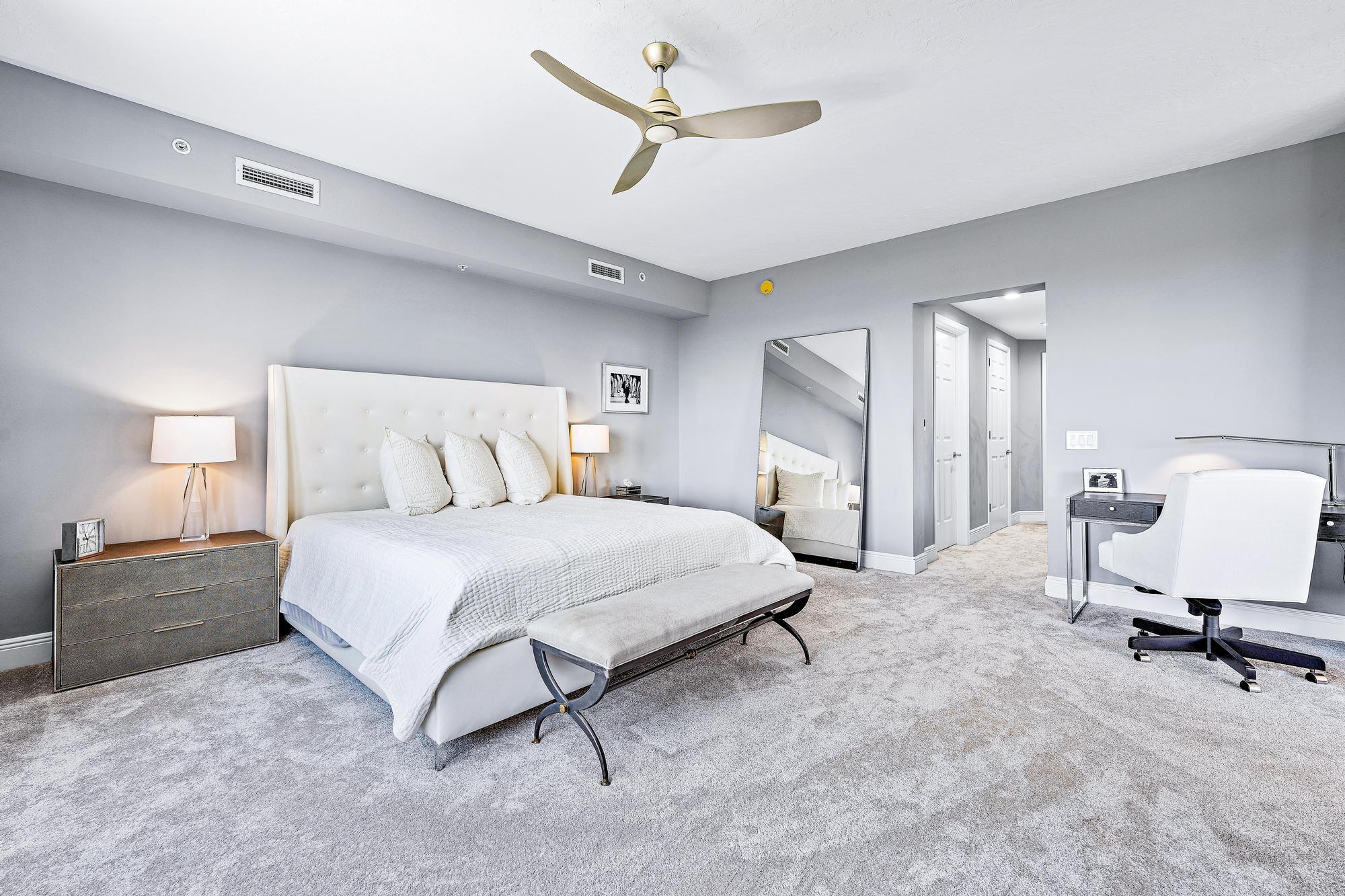 500 Highway 1, Unit 201 Jupiter, FL 33477 - Photo 18 of 38 a bedroom with a bed large mirror and a lamp