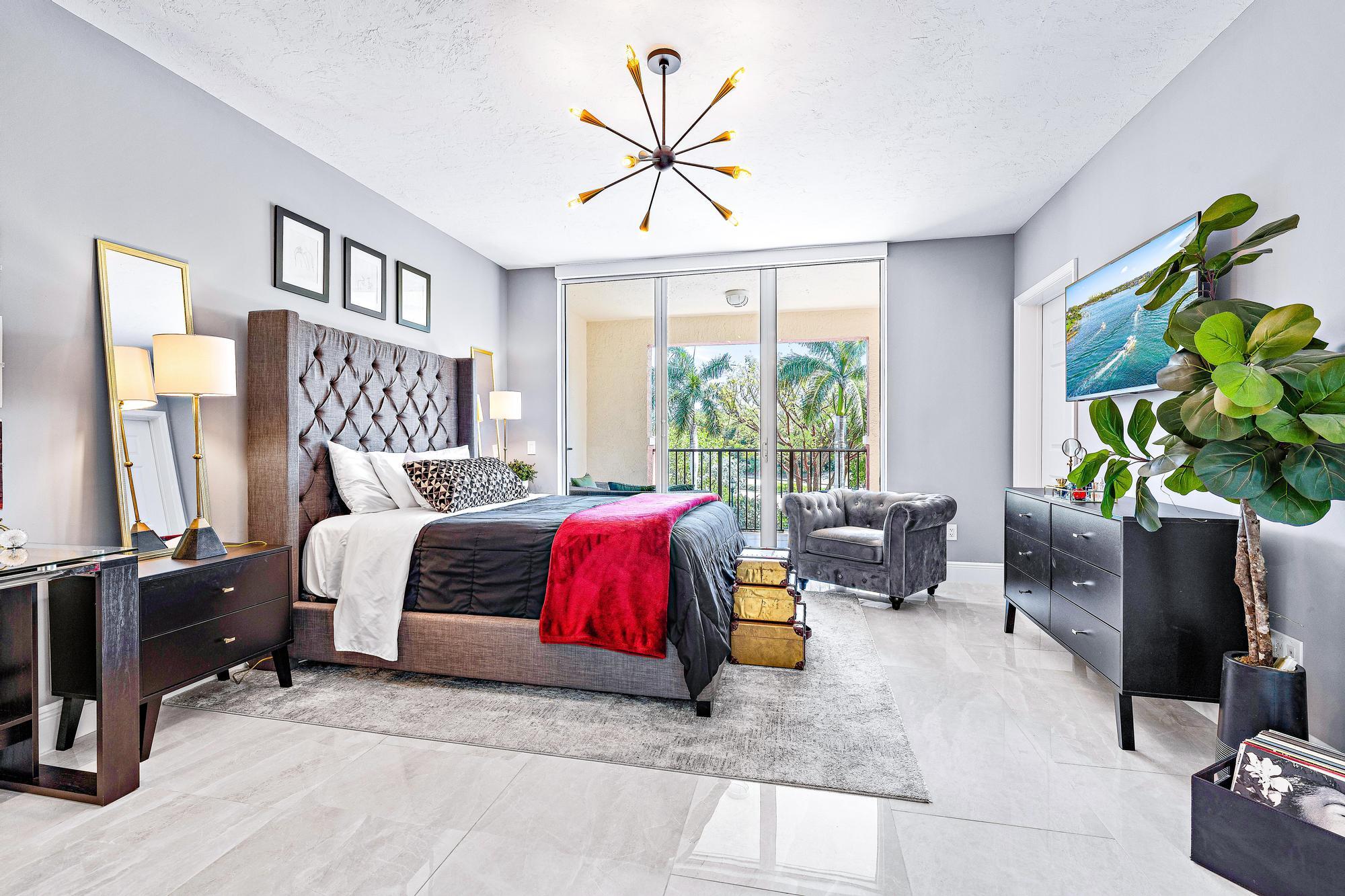 500 Highway 1, Unit 201 Jupiter, FL 33477 - Photo 23 of 38 a spacious bedroom with a bed a couch and a large window