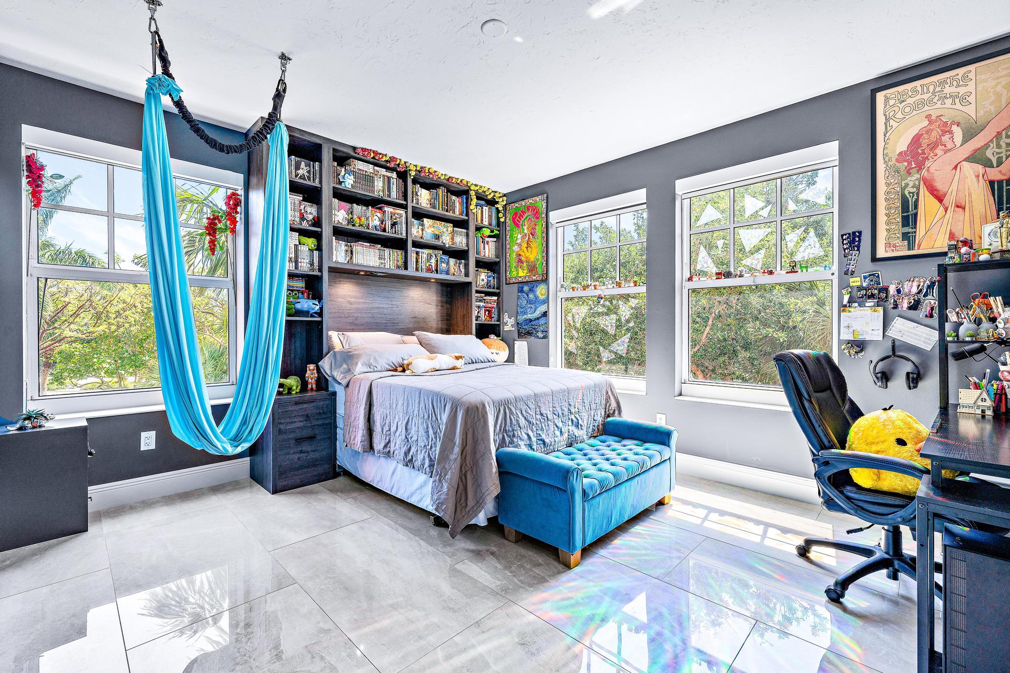 500 Highway 1, Unit 201 Jupiter, FL 33477 - Photo 25 of 38 a bedroom with a bed a flat screen tv and a large window