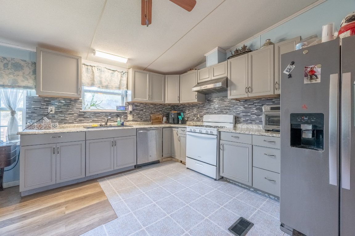 664 Hidden Oaks Drive Elgin, TX 78621 - Photo 11 of 35 a kitchen with a sink cabinets and window