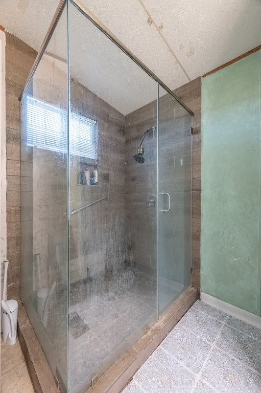 664 Hidden Oaks Drive Elgin, TX 78621 - Photo 14 of 35 a bathroom with a glass shower door