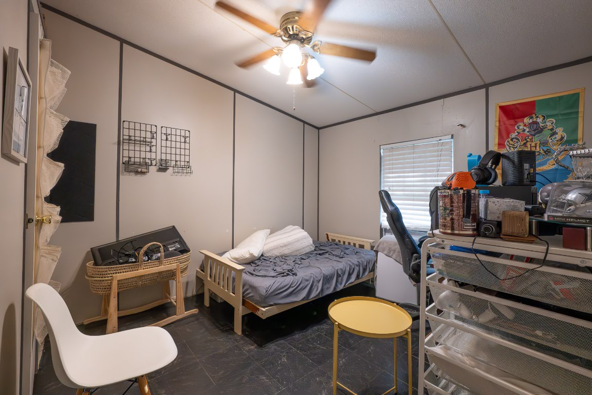 664 Hidden Oaks Drive Elgin, TX 78621 - Photo 15 of 35 a bedroom with bed and a couch