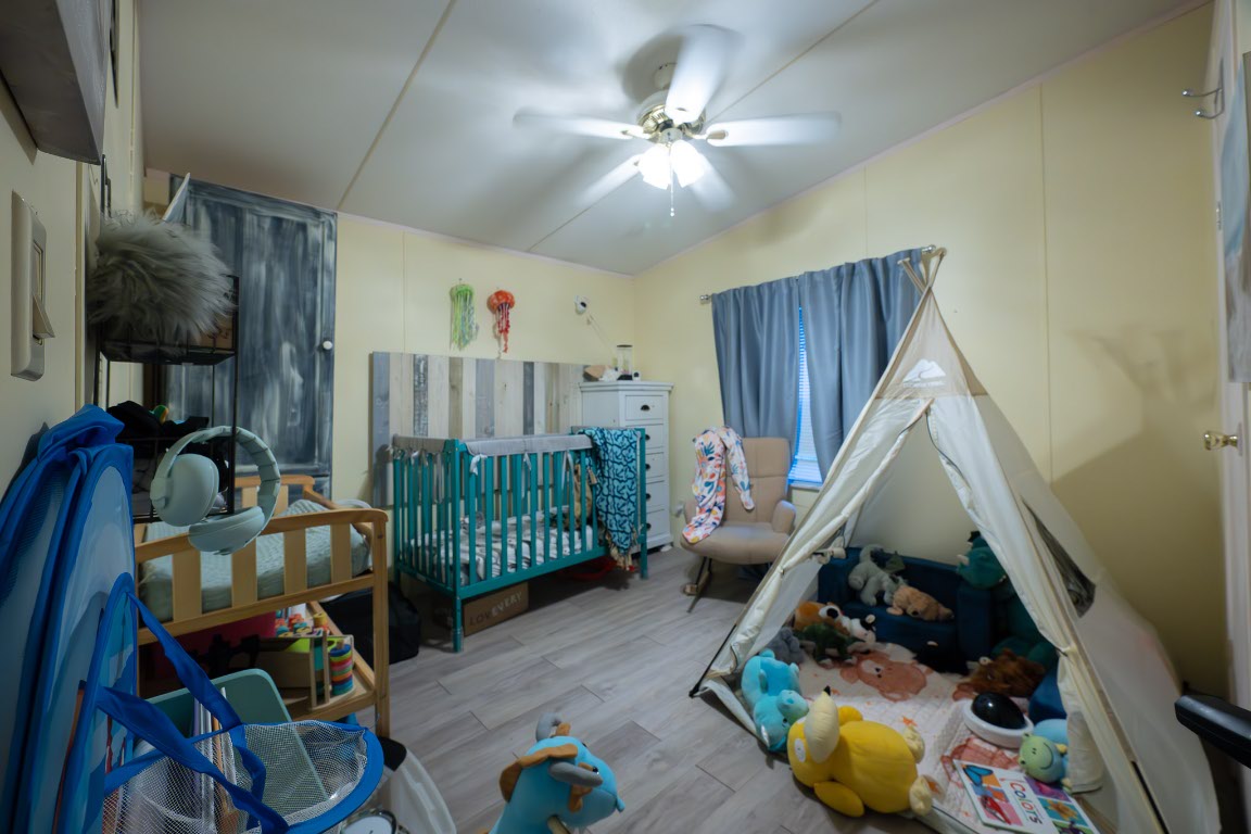 664 Hidden Oaks Drive Elgin, TX 78621 - Photo 16 of 35 a living room with furniture and a chandelier