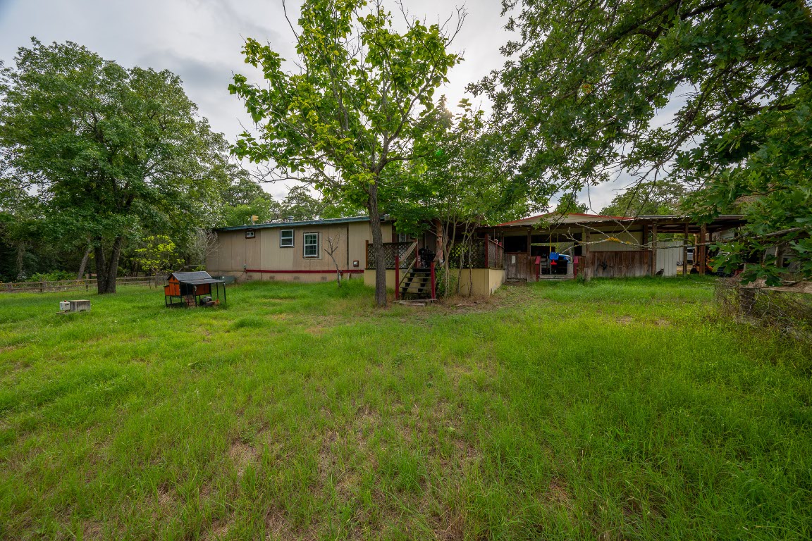 664 Hidden Oaks Drive Elgin, TX 78621 - Photo 27 of 35 a view of a house with a yard porch and sitting area