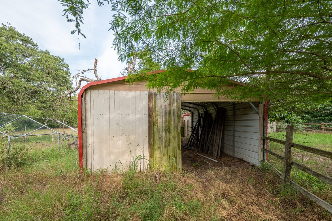664 Hidden Oaks Drive Elgin, TX 78621 - Photo 28 of 35 a backyard of a house with lots of green space