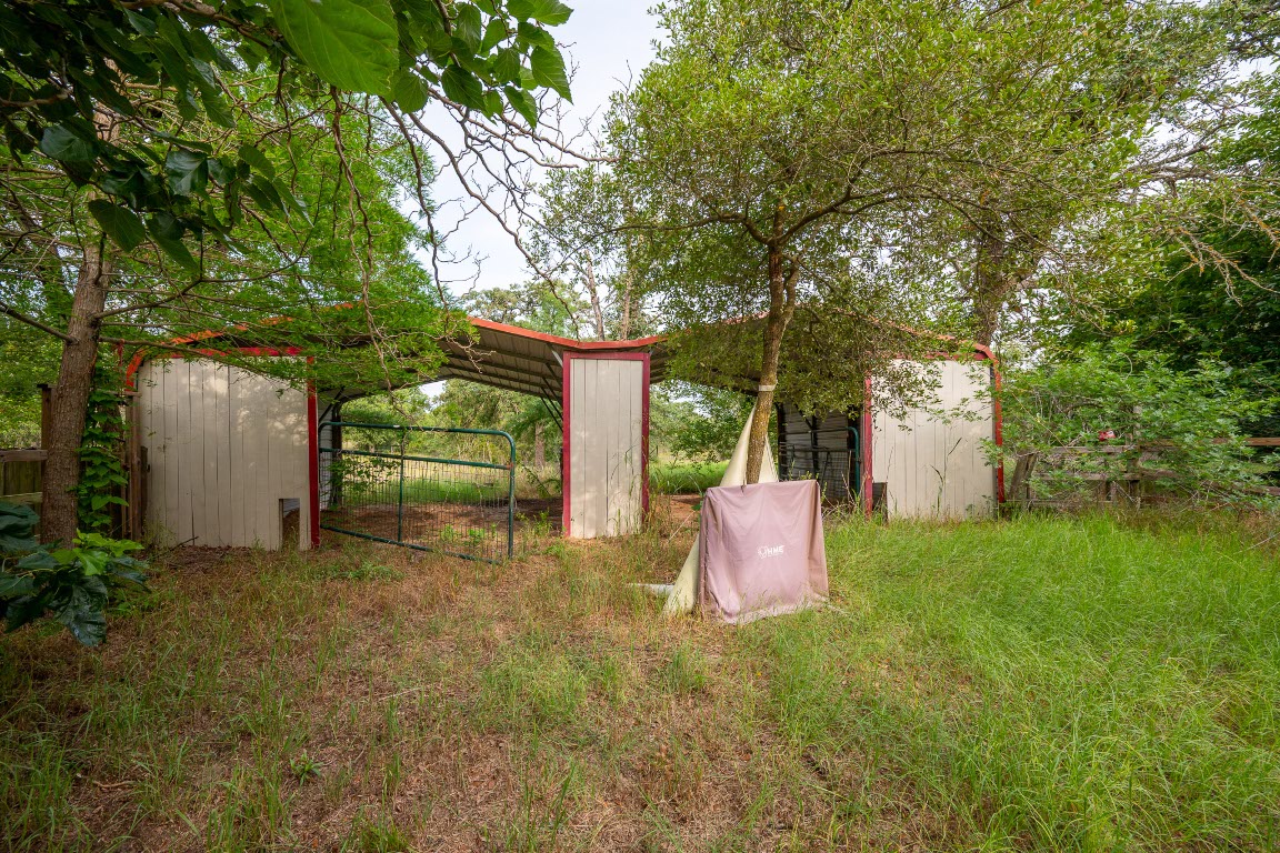 664 Hidden Oaks Drive Elgin, TX 78621 - Photo 30 of 35 a backyard of a house with seating space