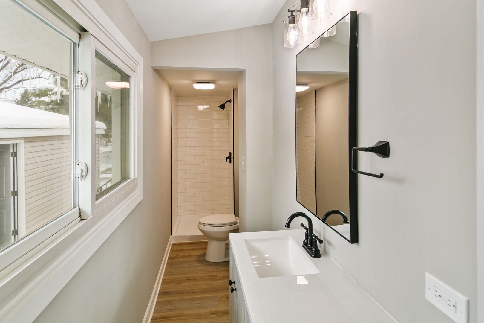 6305 Robert Road Cary, IL 60013 - Photo 15 of 23 a bathroom with a sink a toilet and a mirror