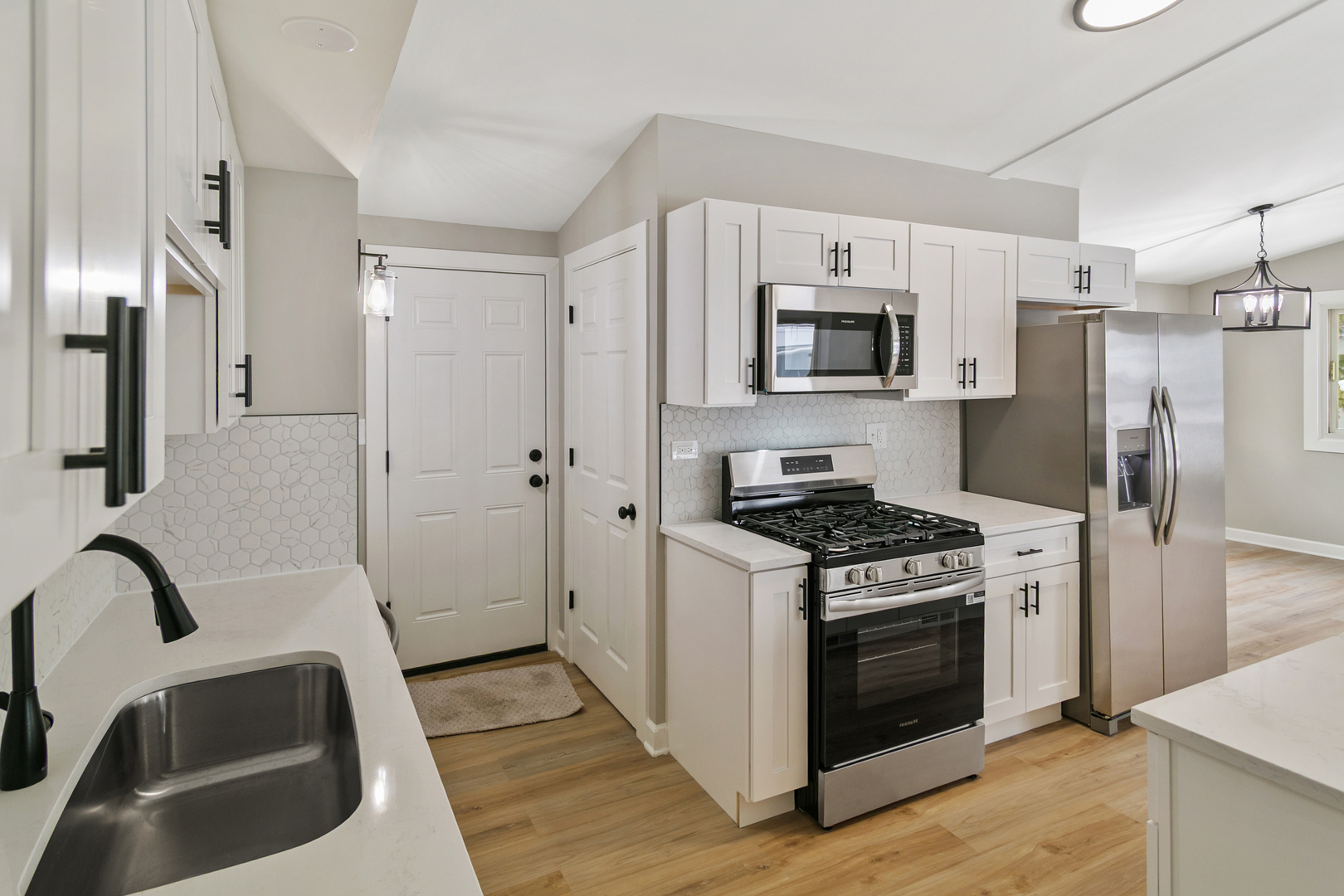 6305 Robert Road Cary, IL 60013 - Photo 4 of 23 a kitchen with stainless steel appliances granite countertop a stove and a refrigerator